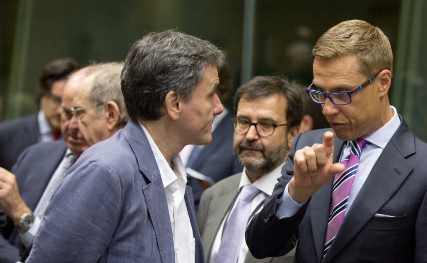 Finnish Finance Minister Alexander Stubb, right, speaks with Greek Finance Minister Euclid Tsakalotos during a round table meeting of eurogroup finance ministers in Brussels on Sunday.