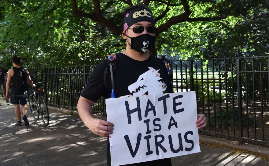 A protestor calls attention to the spike in hate crimes against Asians during the COVID pandemic in 2020.