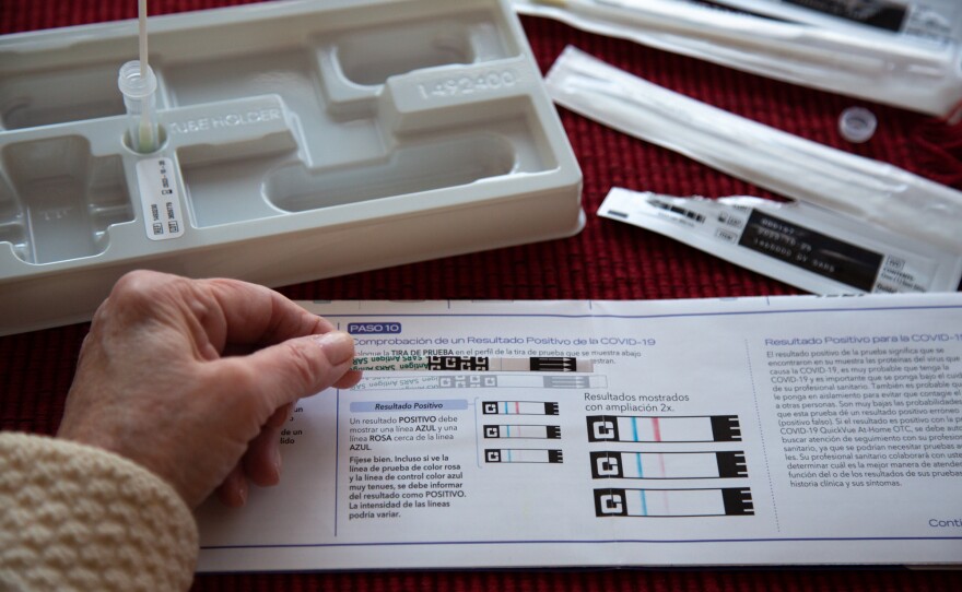 A home tester checks out the result on a test strip.