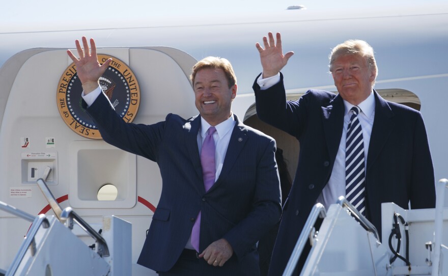 President Trump arrives with Sen. Dean Heller in Nevada on Saturday for a campaign rally.