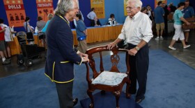 At ANTIQUES ROADSHOW in Atlanta, Ga., appraiser Michael Flanigan (left) tells the delighted owner of this circa 1760 New York Chippendale corner chair—purchased as part of a collection for $750-$800—that the piece actually is valued between $250,000-$300,000.