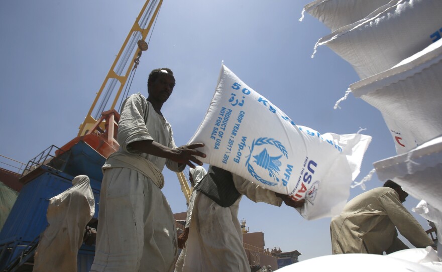 Sudanese dockworkers unload bags of grain from a U.S. ship at Port Sudan on the Red Sea.