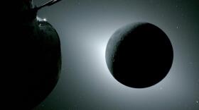 The moon, seen here backlit by the sun during a solar eclipse on Monday, is photographed by one of the cameras on the Orion spacecraft's solar array wings