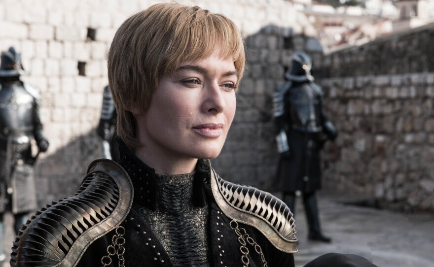 Queen Cersei (Lena Headey) smiling that smile of hers on Game of Thrones. Shoulder pads courtesy of Julia Sugarbaker.