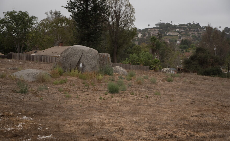 The project would turn a long-vacant six-acre lot, with large boulders, on the southeast corner of Hamilton Lane and Bernardo Avenue into five single-family homes and a stormwater basin.
