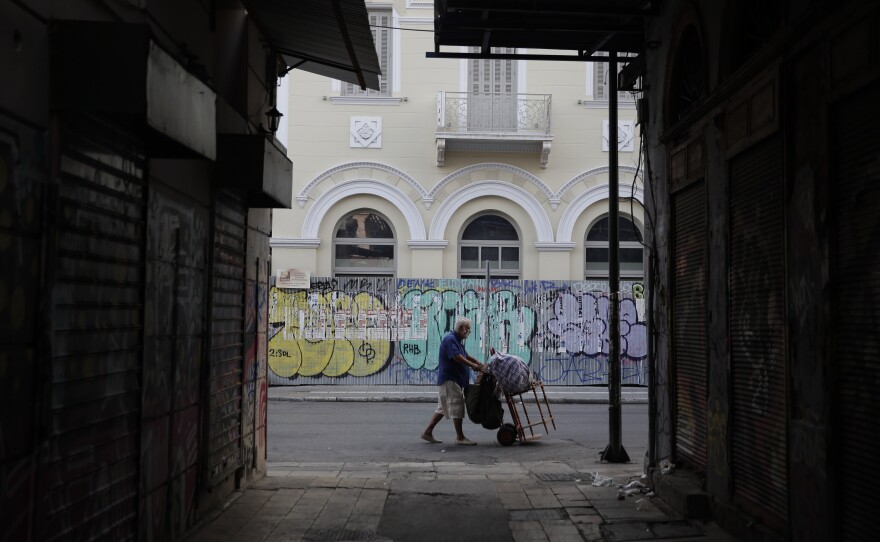 A man pushes a trolley in central Athens, where Joanna Kakissis has made her home. For Kakissis, a Greek-American, the task of reporting on Greece's financial crisis has been both painful and illuminating — a glimpse that only the emotional middle-distance can afford.