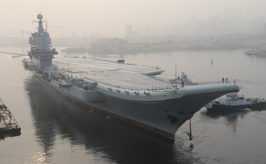 China's first domestically manufactured aircraft carrier, known only as "Type 001A", leaves port in the northeast city of Dalian in May. The vessel has reportedly begun sea trials ahead of its commissioning, expected next year.