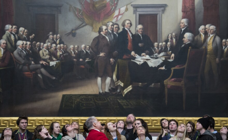 Tourists look up to the Capitol Rotunda as they stand in front of John Trumbull's Declaration of Independence painting on March 10, 2014.