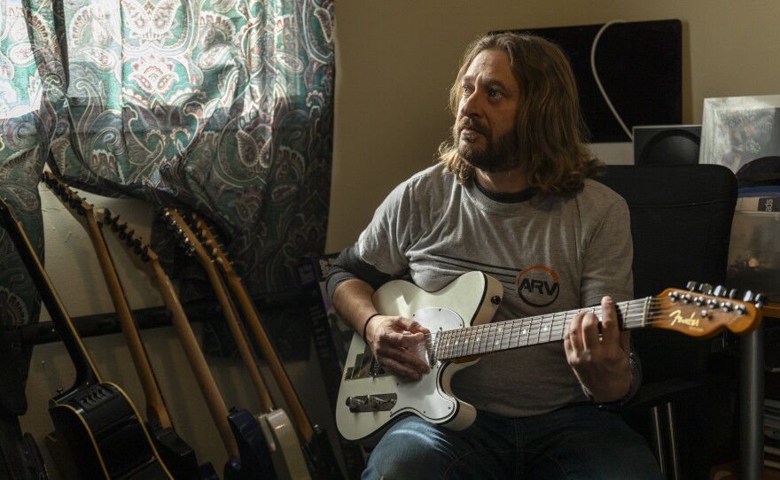 Bill Kowalcic in his music room. In his time off, he enjoys performing with his heavy new wave band Public Squares.