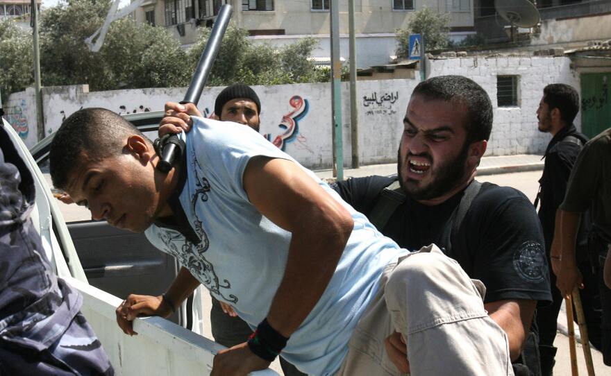 Members of the Hamas security forces arrest a Fatah supporter during a rally in Gaza City on Aug. 31, 2007. Hamas defeated Fatah in heavy fighting in Gaza in June 2007.