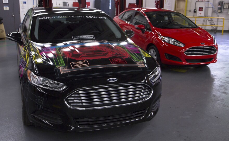 Ford says it cut the weight of its concept Fusion (left) by nearly 25 percent, matching the weight of a Ford Fiesta (right).