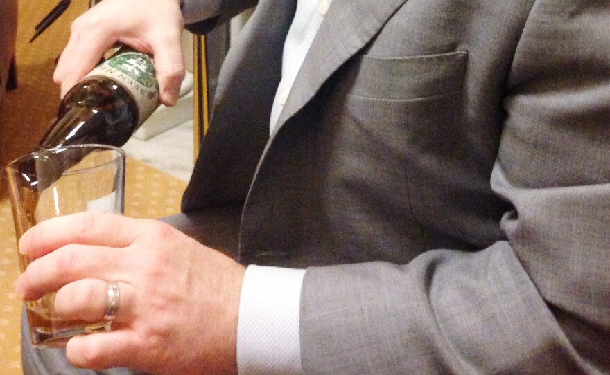 "Brewers in my district are about not only about the sort of art of brewing, they're about jobs," says Rep. Patrick McHenry, seen pouring a beer in his Capitol Hill office.