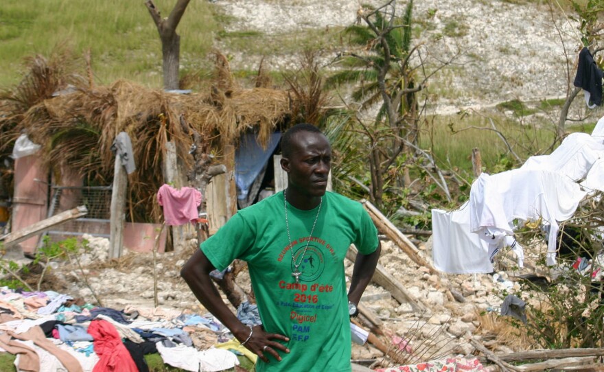 Emmanuello Charlien, a volunteer, assesses hurricane damage in Port Salut.