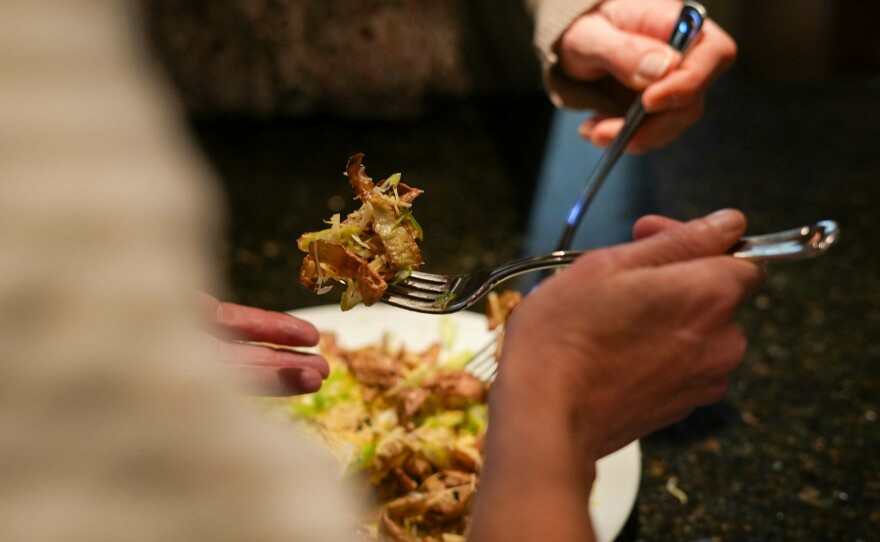 The crispy potato peels are tossed with salt, and topped with cheese and scallions to create a nacho-like dish.