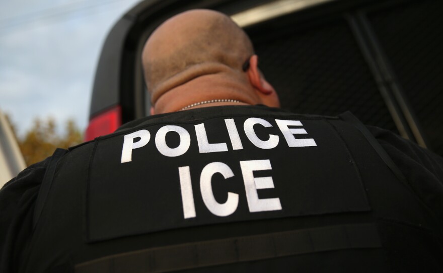 U.S. Immigration and Customs Enforcement agents detain an immigrant on Oct. 14, 2015, in Los Angeles.