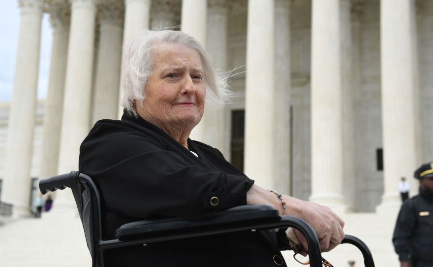 Transgender activist Aimee Stephens sits in her wheelchair outside the Supreme Court on Oct. 8, 2019, as the court holds oral arguments in cases dealing with workplace discrimination based on sexual orientation.