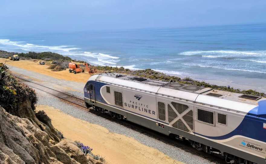 An Amtrak Pacific Surfliner train passes through the tracks on the bluffs of Del Mar on May 21, 2025.