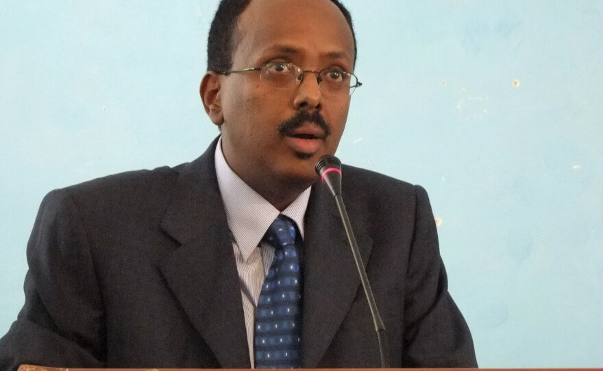 <p>Mohamed Abdullahi Mohamed addresses officials after being sworn in as interim prime minister of Somalia last November. </p>