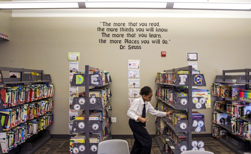 A student picks out a book for silent reading time at St. Marcus Lutheran School in Milwaukee.