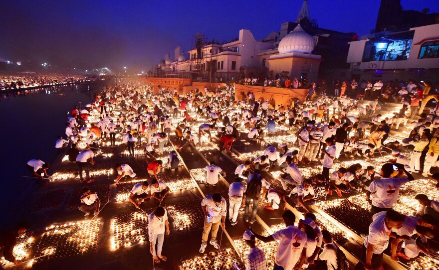 People light earthen lamps on the banks of the river Sarayu during Deepotsav celebrations on the eve of the Hindu festival of Diwali in Ayodhya.