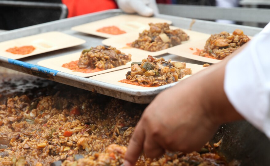 Volunteers prepare to hand out plates of paella made by celebrity chef José Andrés and his team.