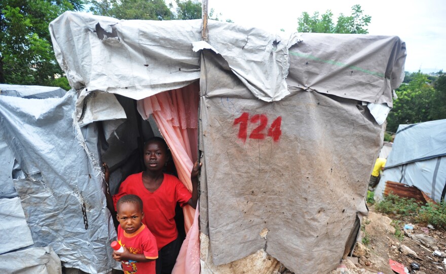 Boys at a camp for earthquake victims look out from their shelter in Petion-ville, Haiti, outside of Port-au-Prince in November.