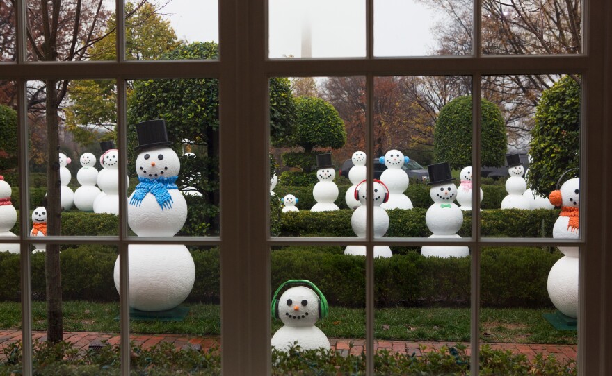A collection of 56 "snow people" stand outside the East Collannde. The sculptures represent all 50 states and six U.S. territories.