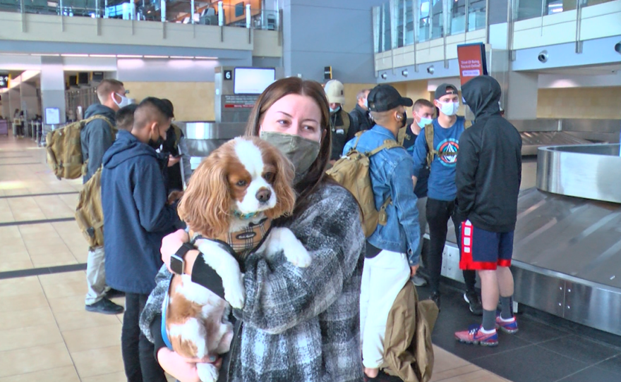 Omaha native Katarina Nelson and her pup Butters wait for their baggage after they arrived at the San Diego International Airport for the Thanksgiving holiday on Nov. 23, 2021. 