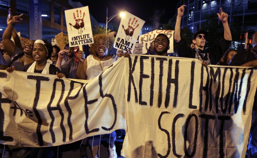 People march in Charlotte, N.C., on Sept. 23 to protest the fatal police shooting of Keith Lamont Scott. The Mecklenburg County district attorney said Wednesday he was "entirely convinced" that the officer who shot Scott "was lawful in using deadly force."