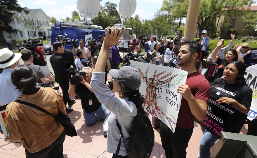 Supporters of the Deferred Action for Childhood Arrivals Act and others demonstrate outside the 9th Circuit Court of Appeals in Pasadena, Calif., in May. The Trump administration failed to convince a U.S. appeals court that it was justified in ending the program, but a Texas judge on Friday ruled in a separate case that DACA was likely illegal.