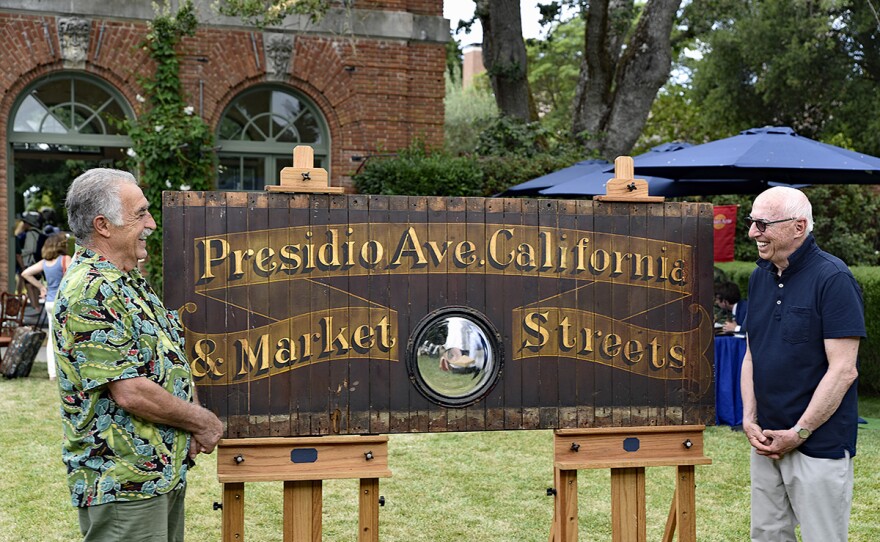 Allan Katz (right) appraises a San Francisco cable car front panel, ca. 1900, in Woodside, Calif.