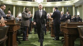 Gov. Jerry Brown is applauded by lawmakers as he walks down the center isle of the Assembly chambers to give his annual State of the State address to a joint session of the Legislature in Sacramento, Jan. 21, 2016.