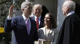 President Donald Trump watches as Supreme Court Justice Anthony Kennedy administers the judicial oath to Judge Neil Gorsuch during a re-enactment in the Rose Garden of the White House White House in Washington, April 10, 2017.