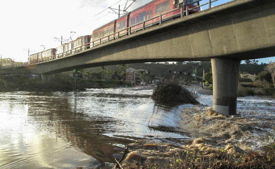 Flooding under a trolley bridge in Mission Valley following heavy rain, Feb. 28, 2017.