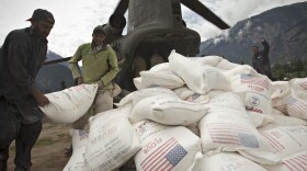Pakistani aid workers offload USAID food supplies from an Army helicopter in Kallam Valley during catastrophic flooding in 2010.