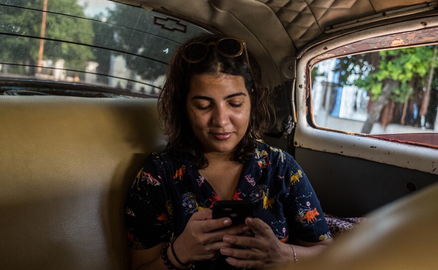 Lauren chats with Jan in a collective taxi in Havana.