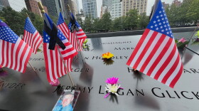Flags and flowers are placed in the inscribed names at the National September 11 Memorial in New York on Wednesday, Sept. 10, 2025.