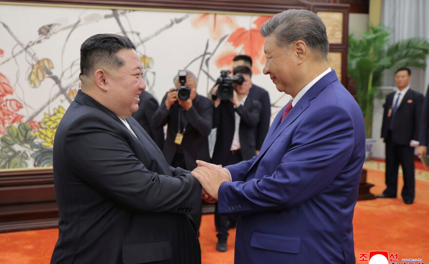 FILE - In this photo provided by the North Korean government, North Korean leader Kim Jong Un, left, shakes hands with Chinese President Xi Jinping in Beijing Thursday, Sept. 4, 2025.