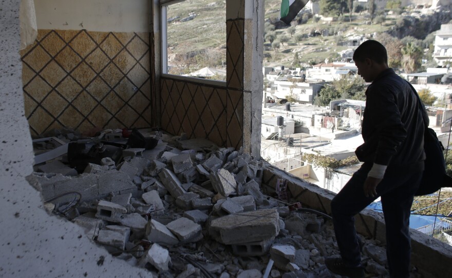 A relative of Abdel Rahman Shaludi, a Palestinian who killed two Israelis with his car last month, stands at his family home after it was razed by Israeli authorities in east Jerusalem Silwan neighborhood on Wednesday.