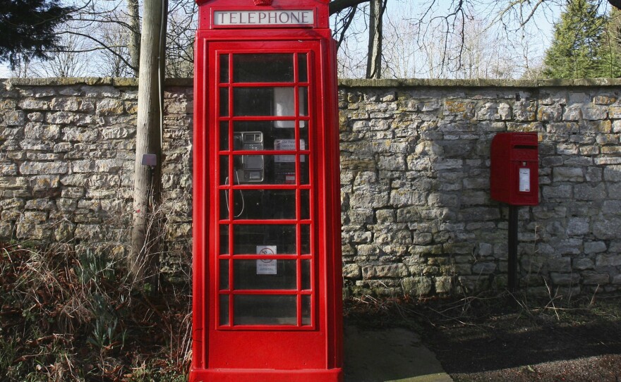 A traditional red telephone box stands in the village of Priston near Bath, in Somerset, England. The boxes are beloved by residents and tourists, but their future is uncertain, as the vast majority of Britons now rely on cellphones to make calls.