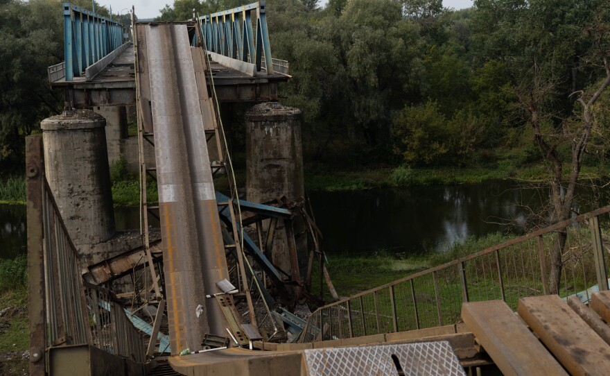 A collapsed bridge over a river in Izium. Ukrainian armed forces estimate 80% of the city is ruined from the violence.
