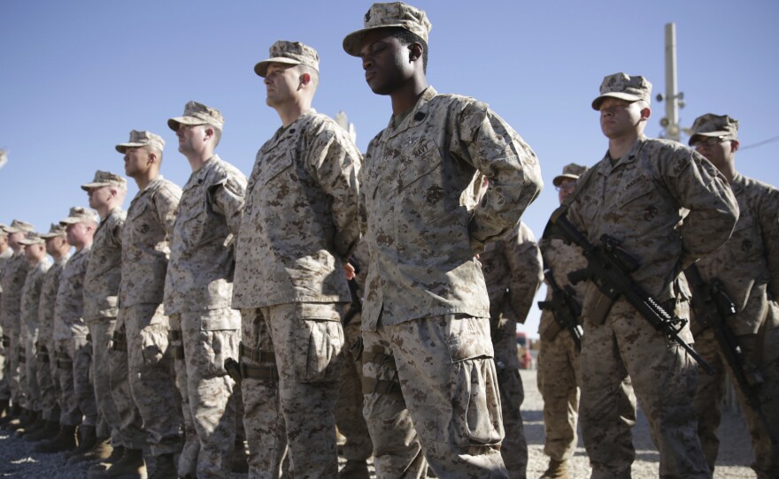 U.S. Marines stand guard during the change of command ceremony at Task Force Southwest military field at Shorab military camp in Afghanistan's Helmand province in 2018.