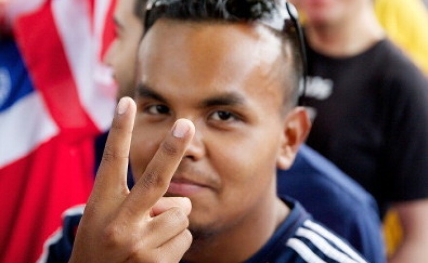 Soccer fan watches US v. Portugal match in Chicago.