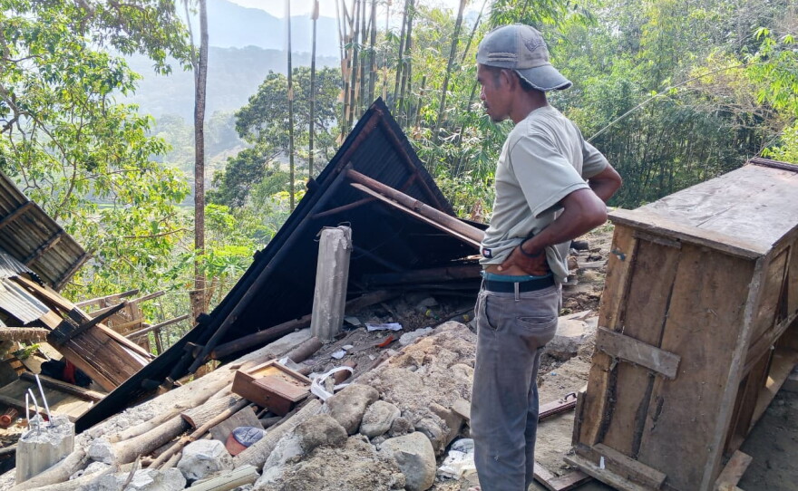 A man examines the damage to a building following an earthquake in East Manggarai, East Nusa Tenggara province, Indonesia, Saturday, Aug. 15, 2026.