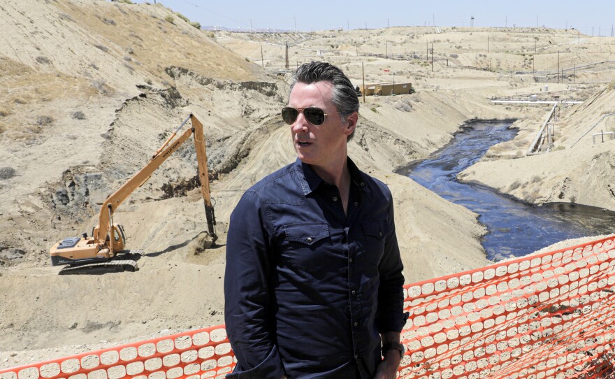 Gov. Gavin Newsom tours the Chevron oil field west of Bakersfield, where a spill of more than 800,000 gallons flowed into a dry creek bed in McKittrick, Calif. in July 2019.