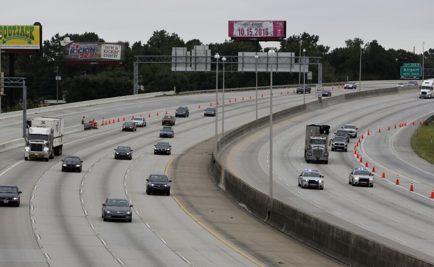 South Carolina state troopers (right) lead the first wave of cars evacuating on the reversed lane of Interstate 26 on Wednesday, as the state prepares for Hurricane Matthew.