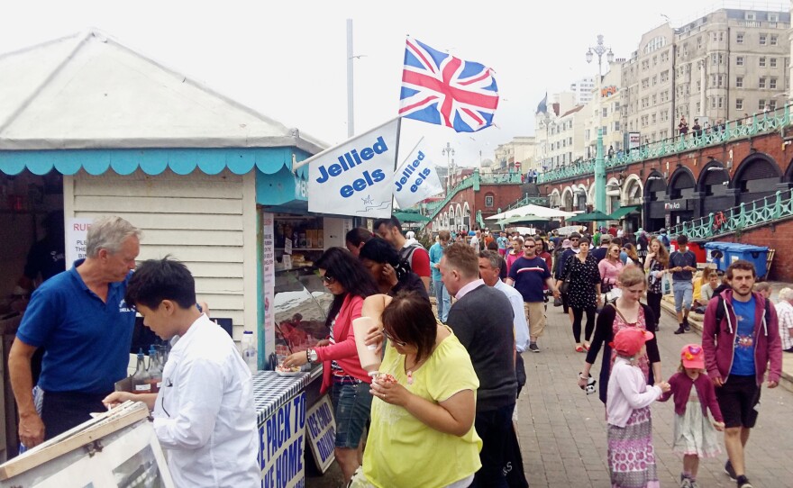Cliff Faires (left, in blue shirt) is the owner of the Brighton Shellfish & Oyster Bar. He started selling seafood on the Brighton boardwalk as a relaxed, retirement gig 10 years ago. But Brexit is already hurting his bottom line.