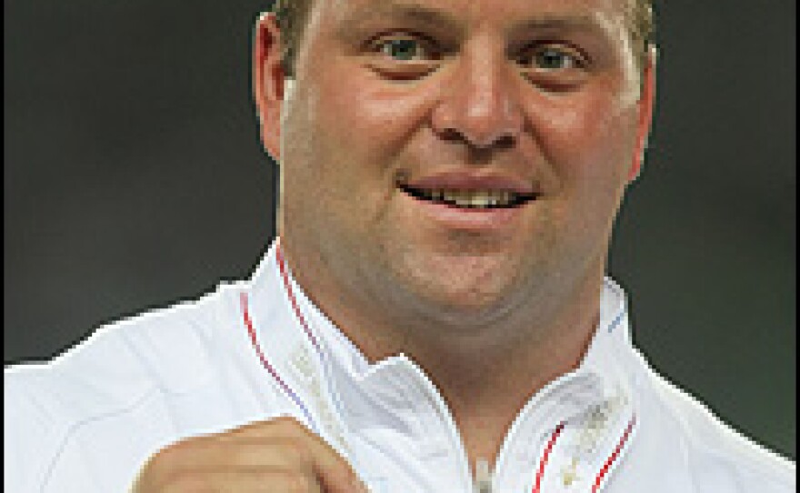 Adam Nelson holds the silver medal he won in 2007 at the IAAF World Athletics Championships in Osaka, Japan.