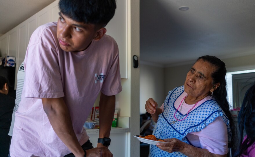 Kevin talks with his grandmother during the tacos de carnitas gathering the day after his birthday party. His grandmother came to California for the celebration. Kevin and his family used to share the same house in Michoacán; after they left, his grandfather died of COVID-19.