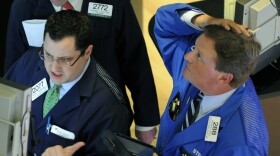 A trader on the floor of the New York Stock Exchange looks at stocks during the final minutes of trading on May 6. The Dow fell more than 600 points in a few minutes in what became known as the "flash crash."